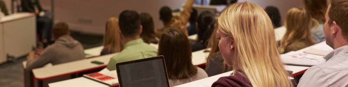 Adult student using laptop computer at a university lecture